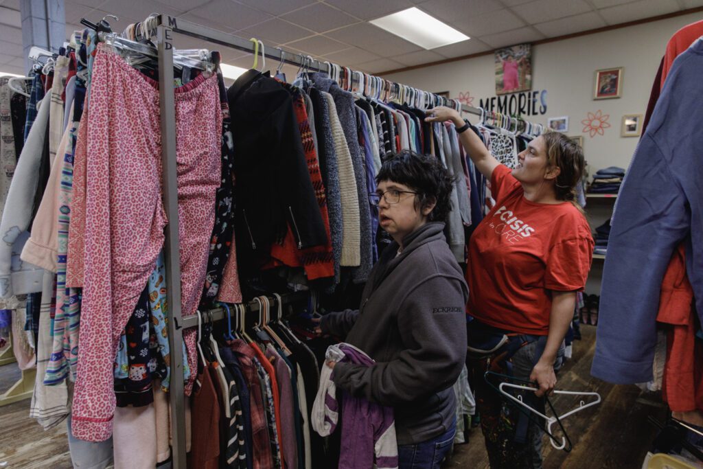 Two workers straighten clothing at The Wearhouse Thrift Store in Waterville, KS. TVDSI finds many ways to provide work opportunities for people with IDD.