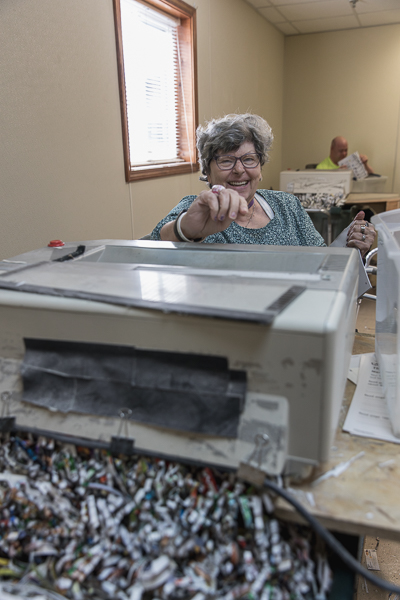 Woman works shredding documents at a day center serving adults with intellectual and developmental disabilities. The individuals we serve want to live productive, fulfilling lives, just like anyone else.