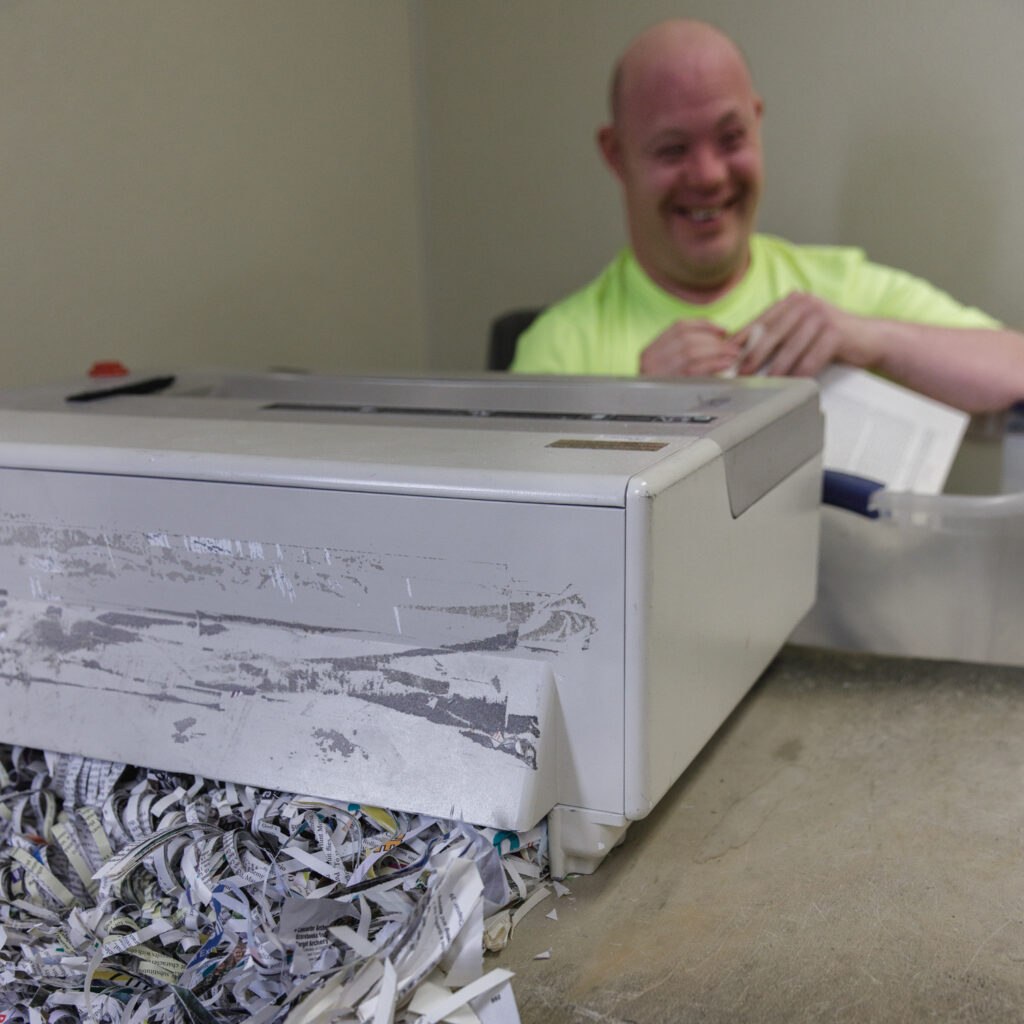 A man shreds documents at TVDSI's Day Center for adults with disabilities in Greenleaf, KS.
